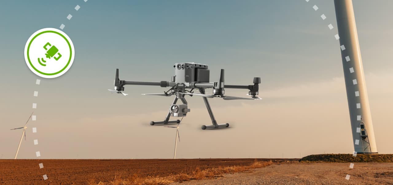 A drone surrounded by a dotted circle and connected with a green satellite icon, on a background of wind farms